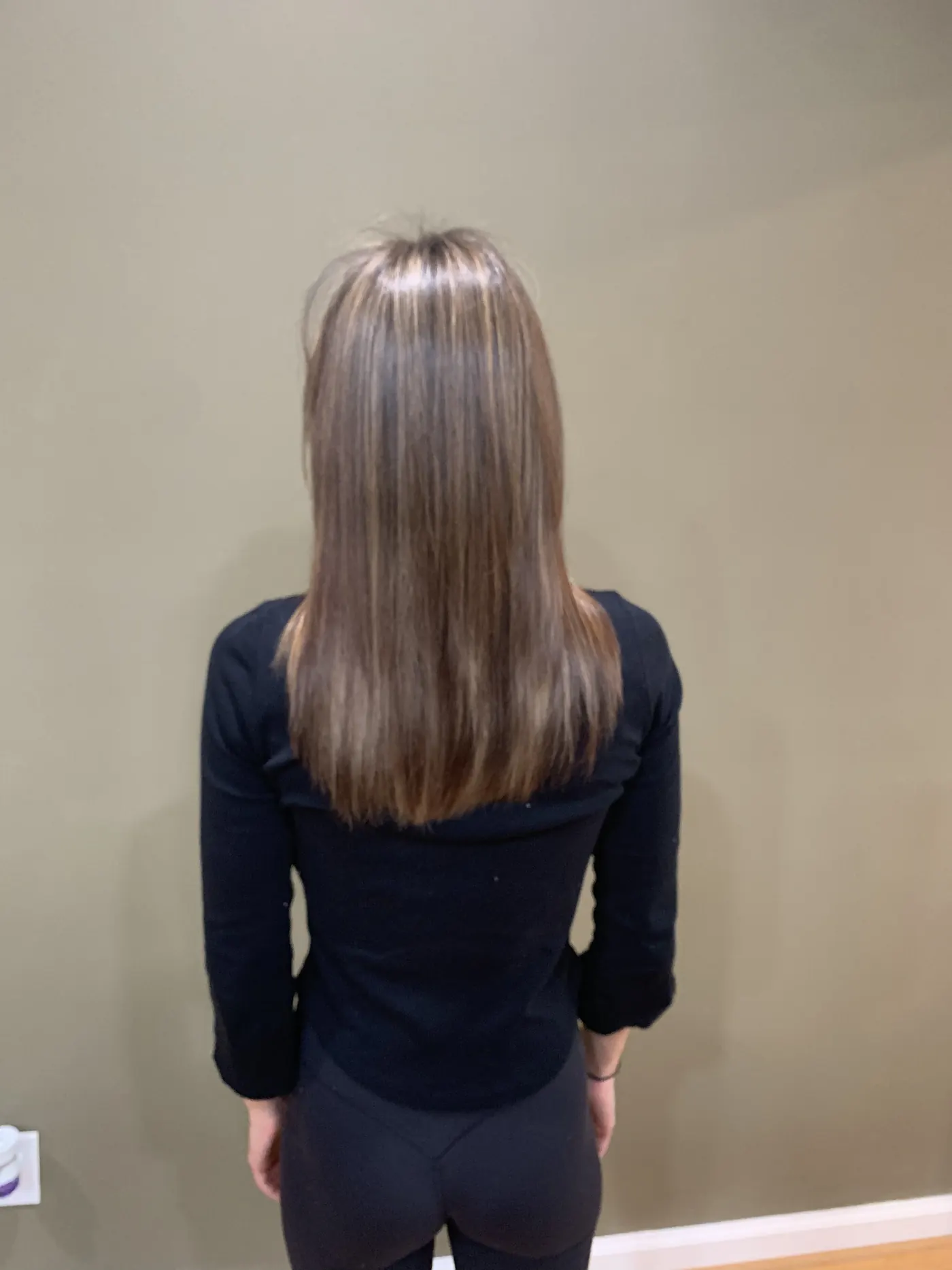 Fine straight hair with highlights, finished and viewed from behind.