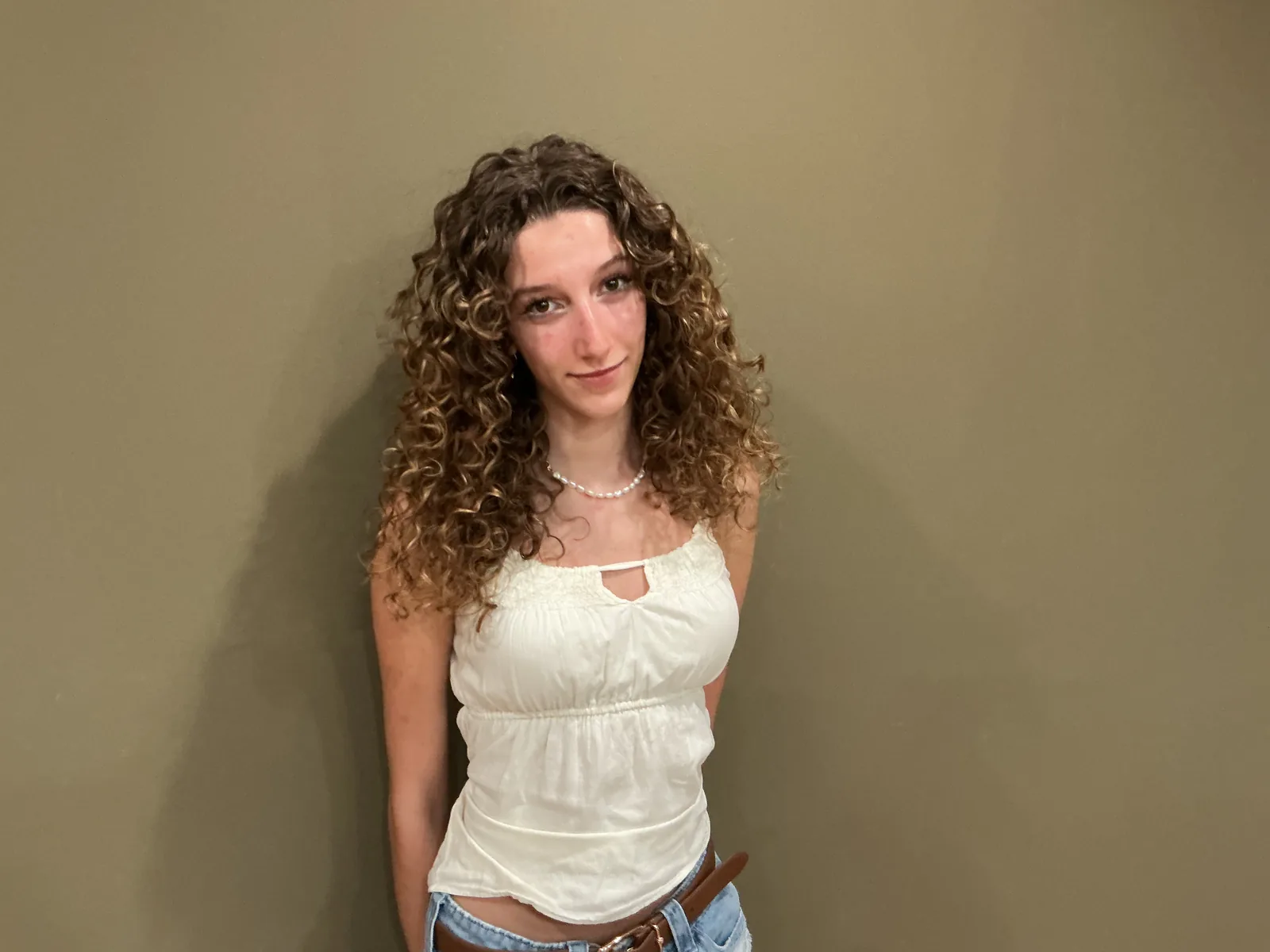 A client with long curls after a haircut.