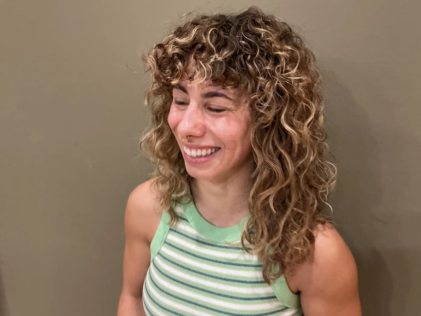 A client's fresh curly cut with bangs, shaped curl by curl.